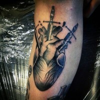 Big black ink bleeding heart with swords tattoo on leg