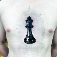 Big black ink chest tattoo of large chess figure