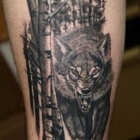 Big black ink colored angry wolf if forest tattoo