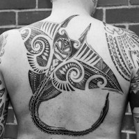 Big black ink colored ray tattoo on back stylized with Polynesian ornaments