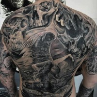 Big black ink detailed fallen angel tattoo on whole back combined with skulls