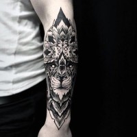 Big black ink detailed forearm tattoo of tribal style lion