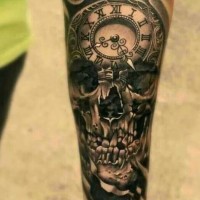 Big black ink detailed skull tattoo on forearm stylized with old clock