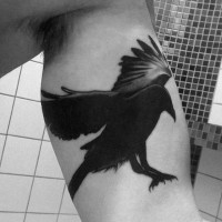 Big black ink eagle shaped bird tattoo on biceps