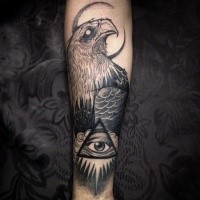 Big black ink forearm tattoo of eagle with mystical eye