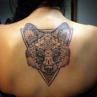 Big black ink fox head tattoo on upper back stylized with various tribal ornaments