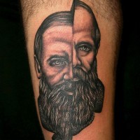 Big black ink fragmented portrait tattoo on thigh
