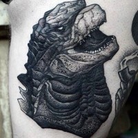 Big black ink Godzilla head tattoo on arm