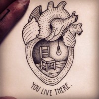 Big black ink human heart with chair tattoo combined with lettering