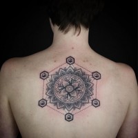Big black ink mysterious figure tattoo on back with ornamental flower