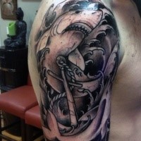 Big black ink shark tattoo on shoulder combined with roped anchor