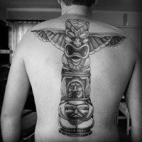 Big black ink tribal Gods statue tattoo on whole back