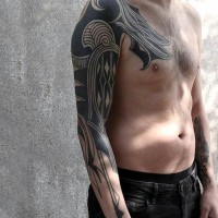 Big black ink tribal style ornaments tattoo on sleeve and chest