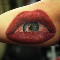 Big blood red lips with eye tattoo on arm by Cris Gherman