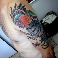 Big colored evil fighting cock tattoo on arm