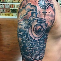 Big colored realistic old western train tattoo with lettering on shoulder