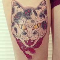 Big colored thigh tattoo of mystical cat with skulls