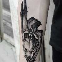 Big dot style forearm tattoo of fantastic animal skull
