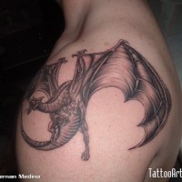 Big fantasy world style colored flying dragon tattoo on shoulder area