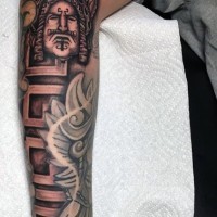 Big half sleeve tribal themed tattoo combined with ambigram
