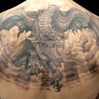 Big horrendous flying dragon tattoo on back