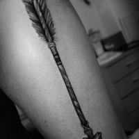 Big indian arrow tattoo on mans leg
