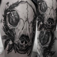 Big interesting looking thigh tattoo of animal skull with flowers