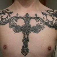 Big iron cross with patterns tattoo on chest