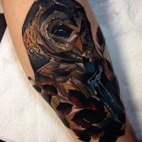 Big multicolored leg tattoo of owl with candle and leaves