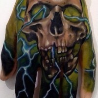 Big multicolored skull in mystic fog tattoo on hand