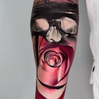 Big mystical designed colored flower with masked man tattoo on arm