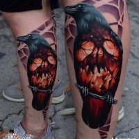 Tatuaje en la pierna,  cuervo tremendo con cráneo ardiente en lugar de estómago