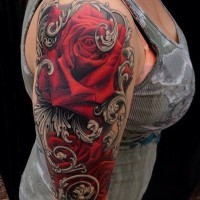 Big red colored very detailed roses tattoo on shoulder