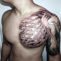 Big religious themed black ink lettering tattoo on chest