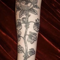 Big simple black ink flower tattoo on sleeve