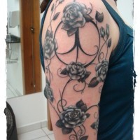 Big traditional painted black and white floral tattoo on shoulder area