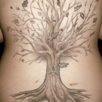 Big tree with falling leaves tattoo