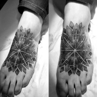 Big tribal style flower shaped tattoo on foot