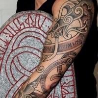 Big typical colored sleeve tattoo of medieval ornaments and lettering