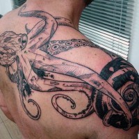 Big very detailed black ink octopus tattoo on upper back