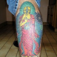 Big yellow buddha tattoo on leg