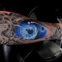 Biomechanical style colored forearm tattoo stylized with human eye and space