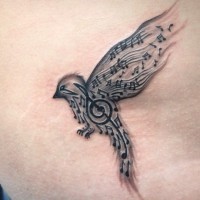Tatuaggio piccolo l'uccello disegnato con le note e la chiave di violino