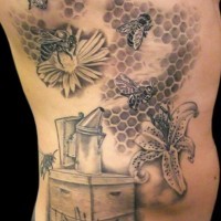 Black and gray beehive and bees on flowers tattoo on ribs