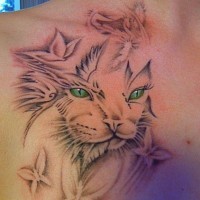 Black and gray cat tattoo with vibrant green eyes
