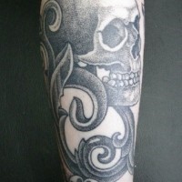 Black and gray skull forearm tattoo