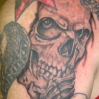 Black and gray skull with star tattoo