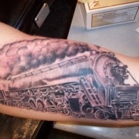 Black and gray style accurate painted train tattoo on biceps