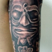 Black and gray style arm tattoo of stone statue