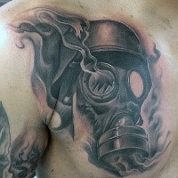 Black and gray style chest tattoo of broken gas mask